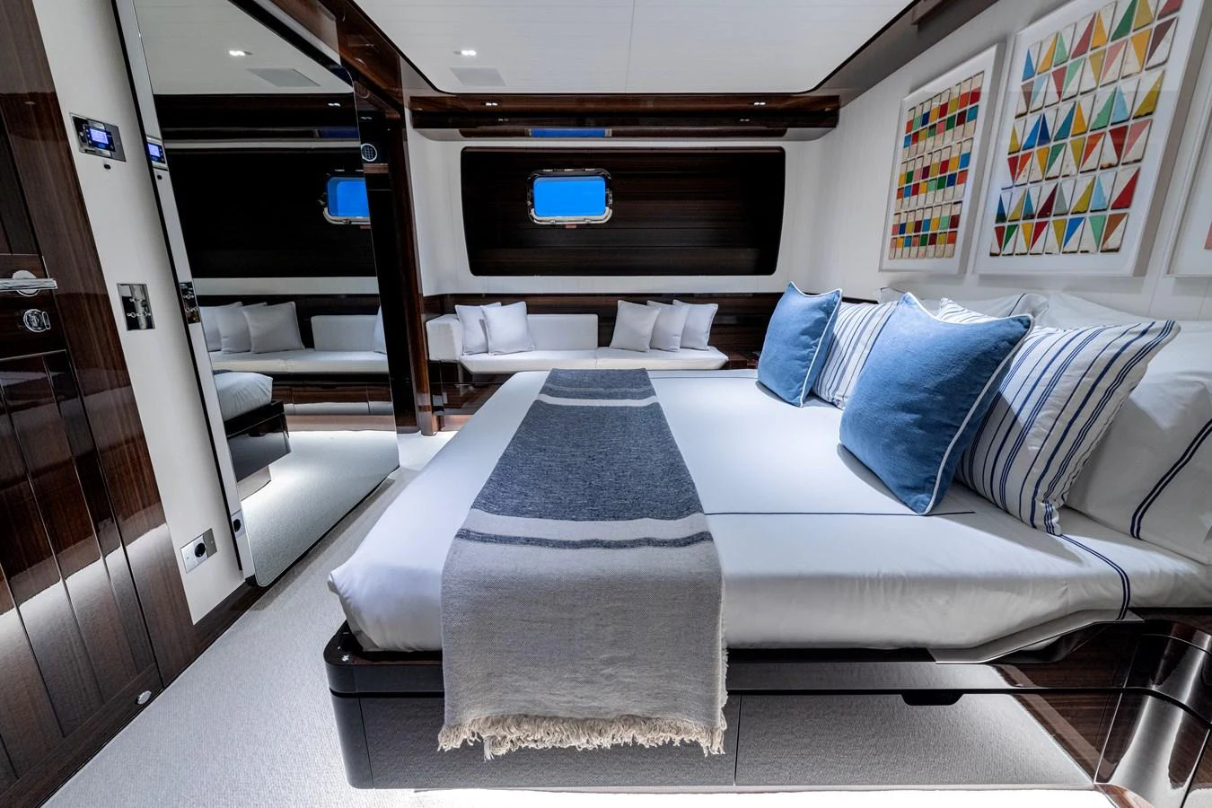 A luxurious stateroom featuring a comfortable bed with stylish bedding and modern decor. aboard CALM Yacht for Sale