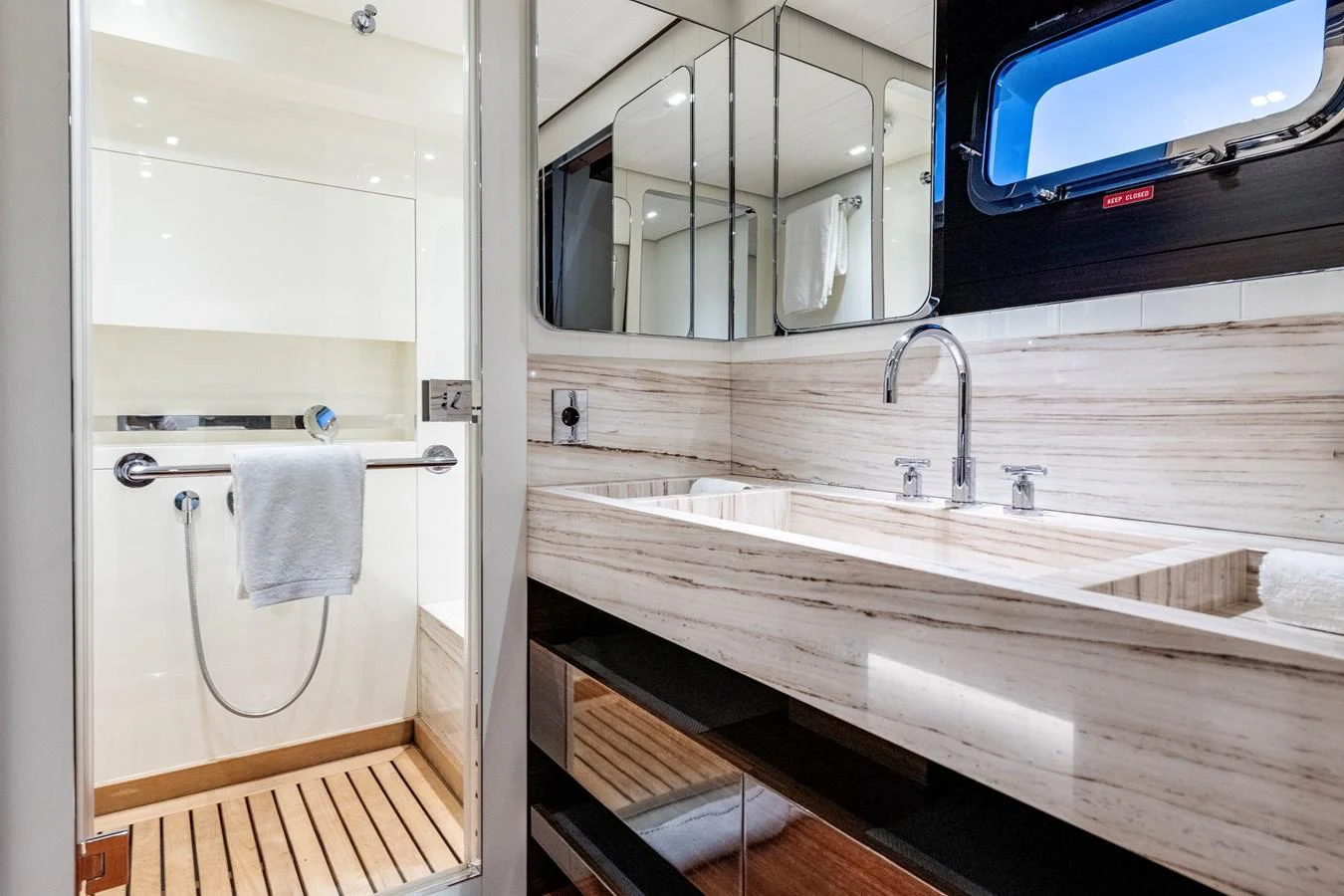 The yacht's bathroom features a sleek design with modern fixtures and ample lighting. aboard CALM Yacht for Sale
