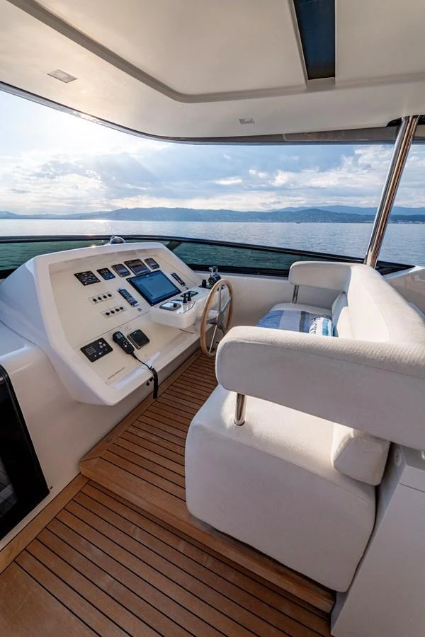 The helm station offers a commanding view with state-of-the-art navigation equipment and luxurious seating. aboard CALM Yacht for Sale