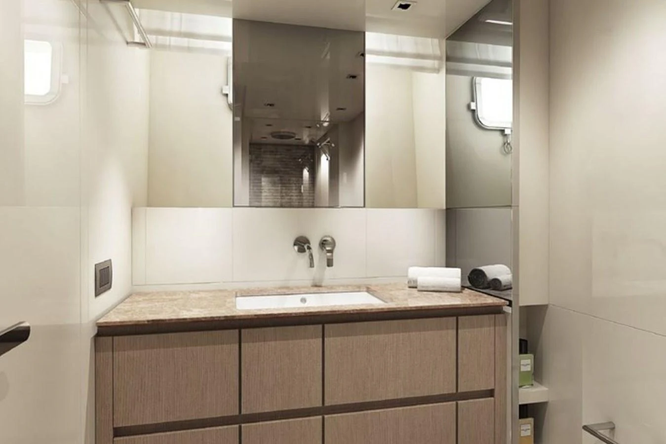 The yacht's bathroom features a sleek vanity with a modern sink and ample storage. aboard SANLORENZO SX 76 KYOMU Yacht for Sale