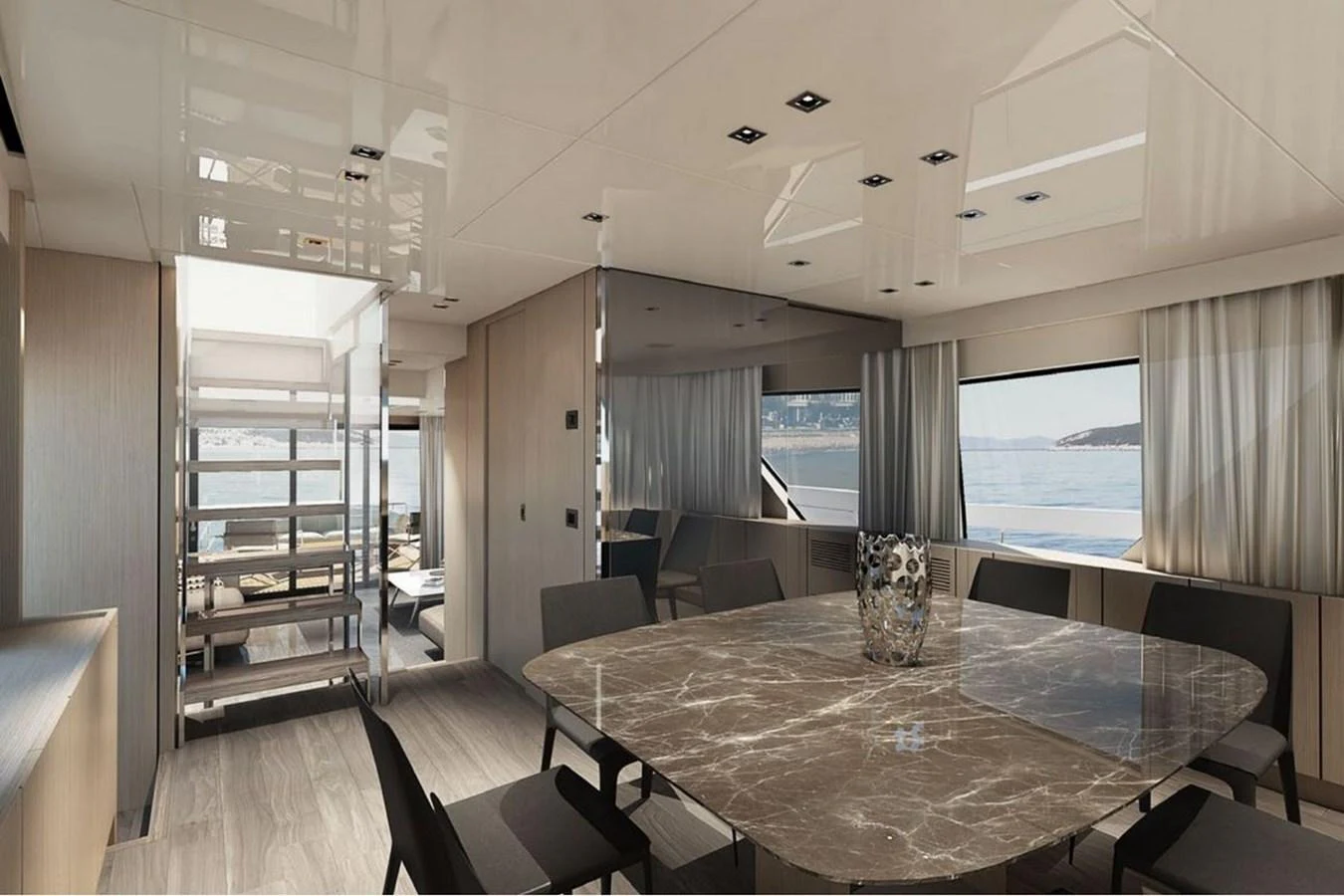 The yacht's dining area features a sleek table with a marble top and comfortable seating, offering stunning views through large windows. aboard SANLORENZO SX 76 KYOMU Yacht for Sale