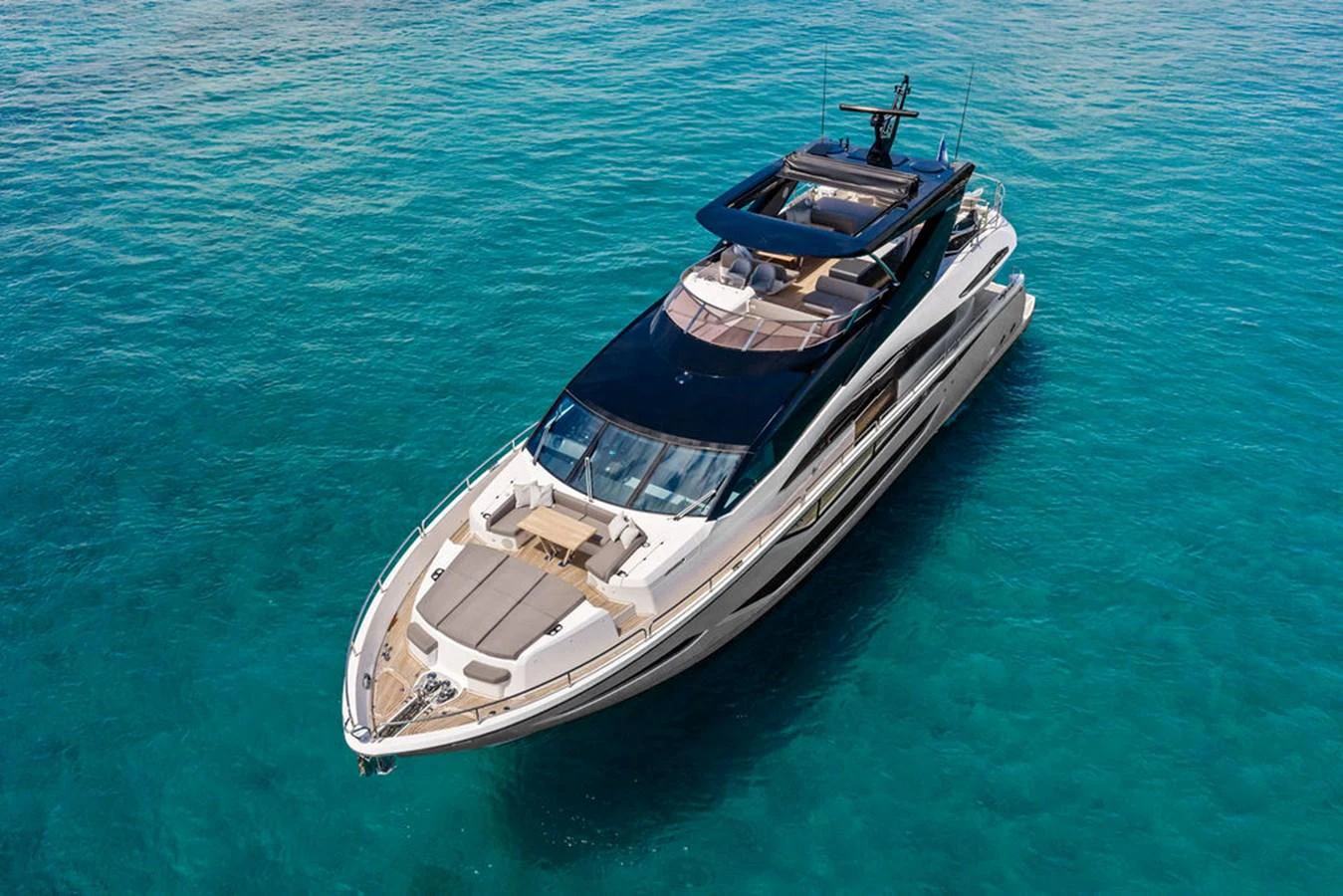 A sleek and modern yacht glides gracefully on clear turquoise waters. aboard DOLCE FAR NIENTE Yacht for Sale