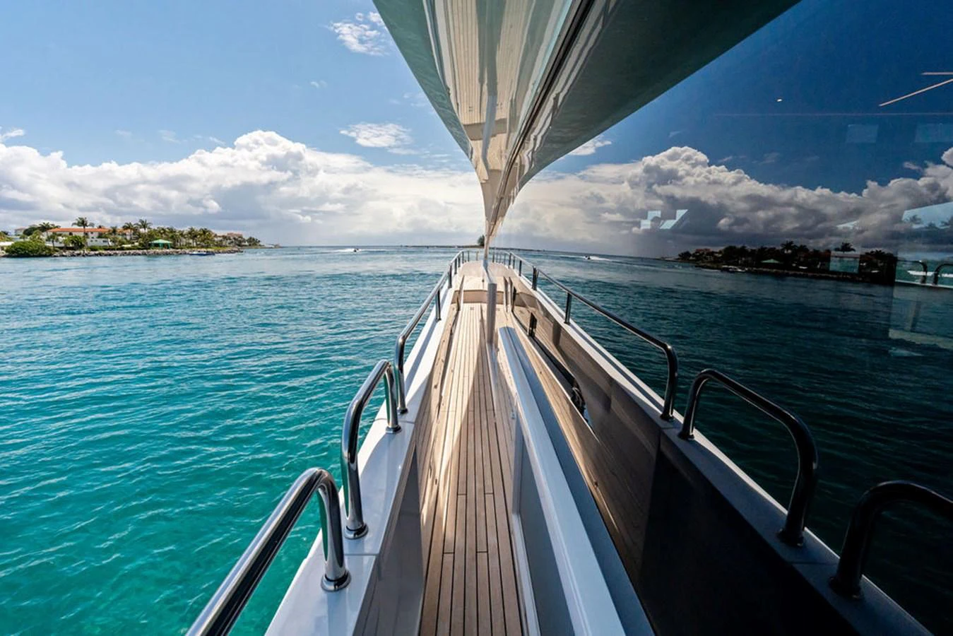 A sleek yacht cruising through clear blue waters, reflecting the scenic surroundings. aboard DOLCE FAR NIENTE Yacht for Sale