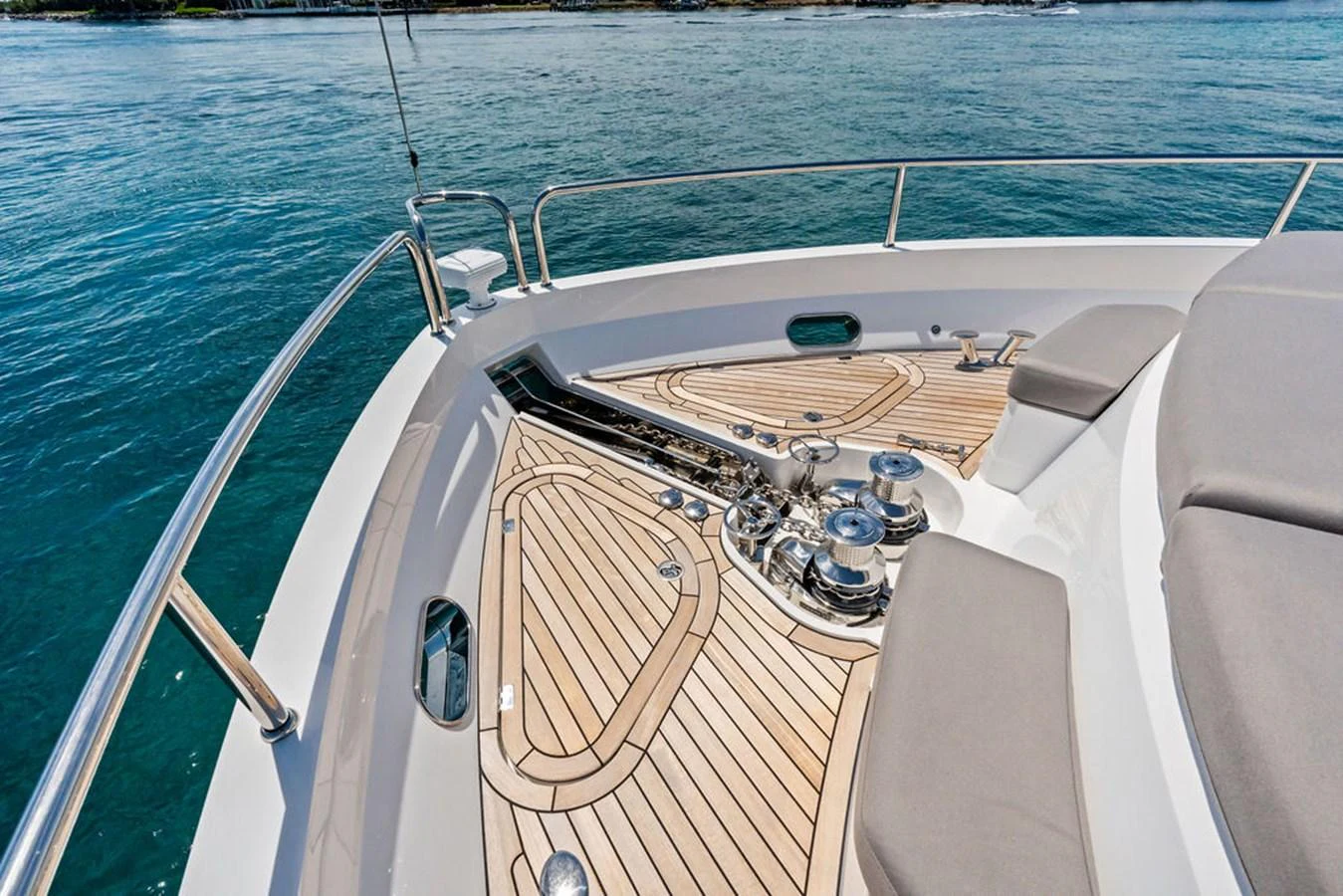 The bow of the yacht features a sleek, modern design with polished metal fittings and teak decking. aboard DOLCE FAR NIENTE Yacht for Sale