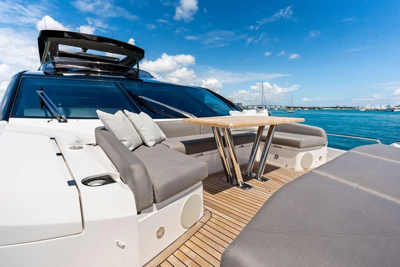 The aft deck features a spacious seating area with a sleek table, perfect for outdoor relaxation and dining. aboard DOLCE FAR NIENTE Yacht for Sale