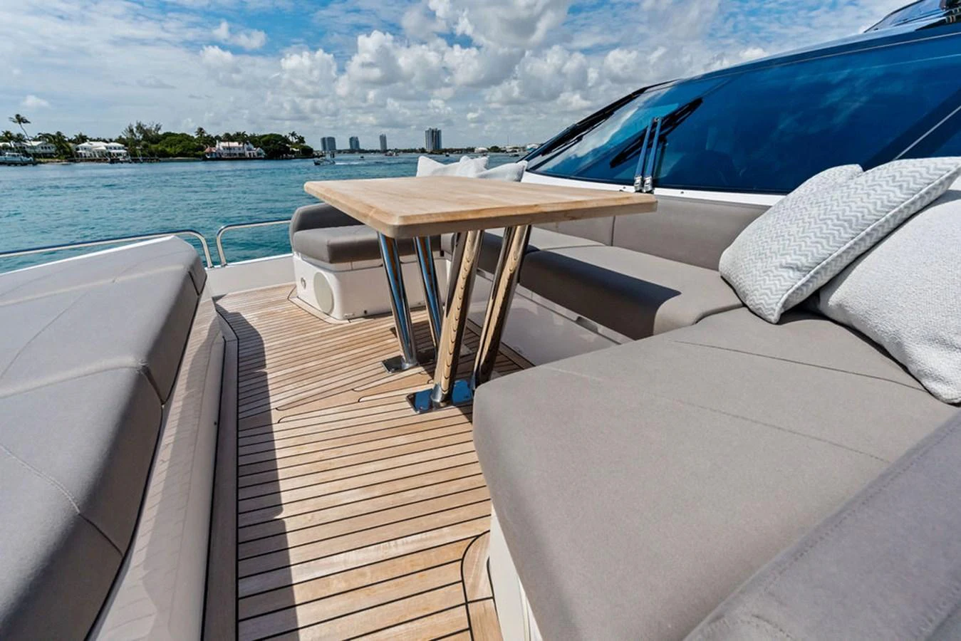 The aft deck features a stylish seating area with a wooden table, perfect for outdoor relaxation. aboard DOLCE FAR NIENTE Yacht for Sale