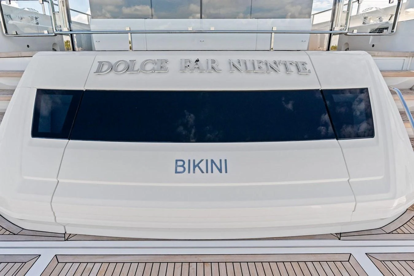 The image showcases a detailed view of a yacht's tender garage with the name 'Bikini' prominently displayed. aboard DOLCE FAR NIENTE Yacht for Sale