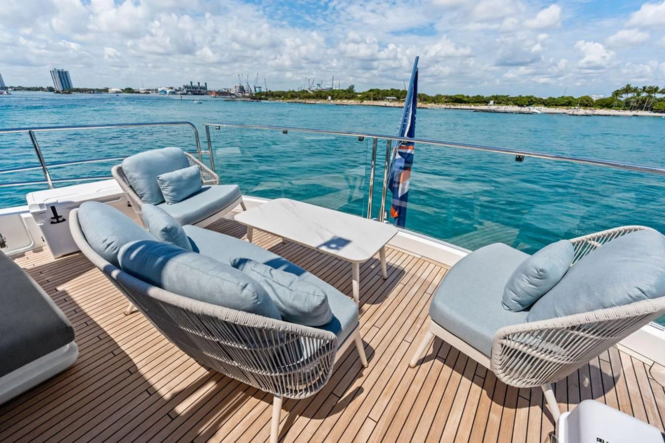 The aft deck offers a serene seating area with plush chairs and a stunning view of the water. aboard DOLCE FAR NIENTE Yacht for Sale