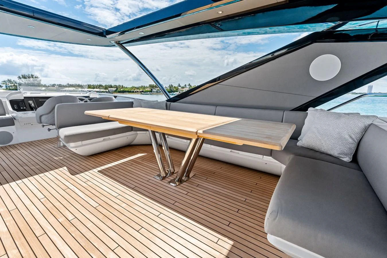 The aft deck features a spacious seating area with a wooden table, perfect for alfresco dining. aboard DOLCE FAR NIENTE Yacht for Sale