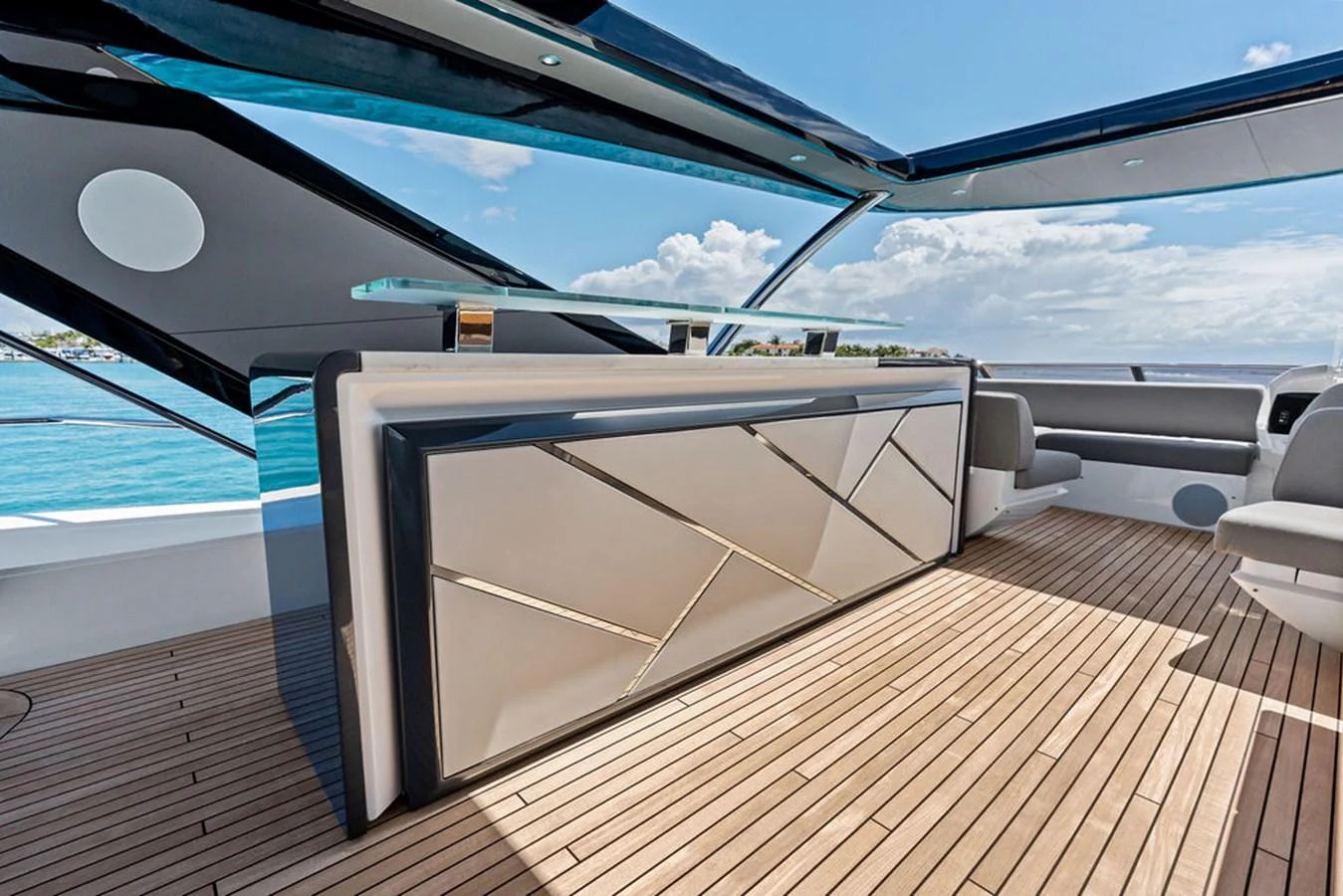 The yacht features a stylish bar area with modern design elements and a beautiful ocean view. aboard DOLCE FAR NIENTE Yacht for Sale
