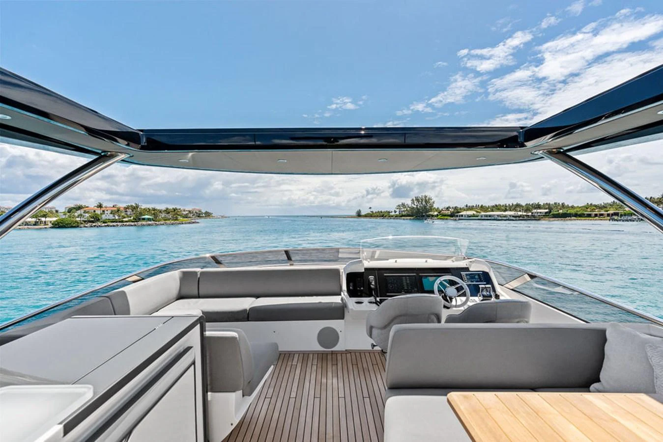 The helm area offers a panoramic view of the serene waters, complemented by modern seating and a sleek design. aboard DOLCE FAR NIENTE Yacht for Sale