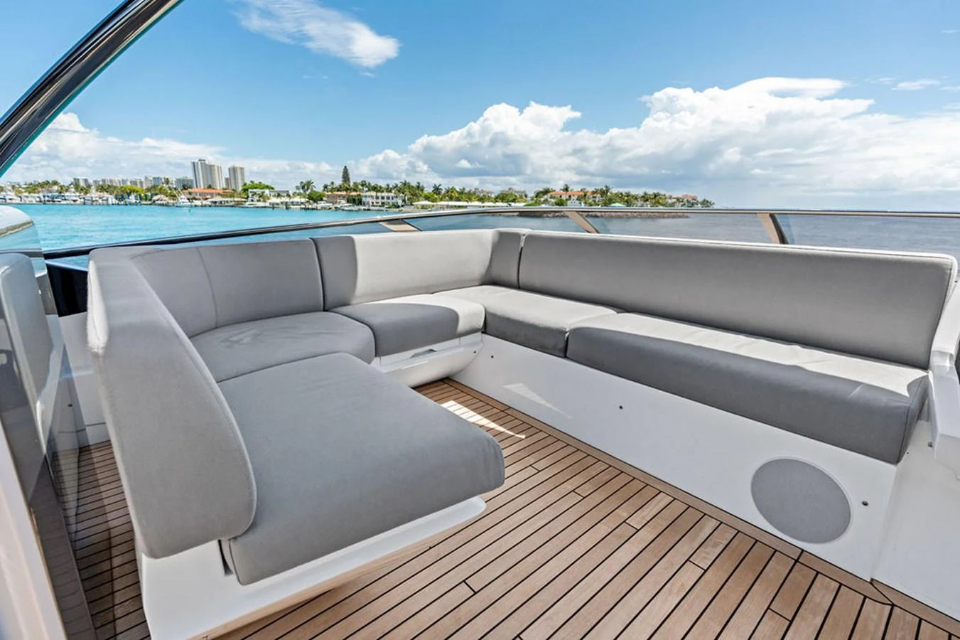 The aft deck features a spacious seating area with plush gray cushions and a beautiful view of the water. aboard DOLCE FAR NIENTE Yacht for Sale