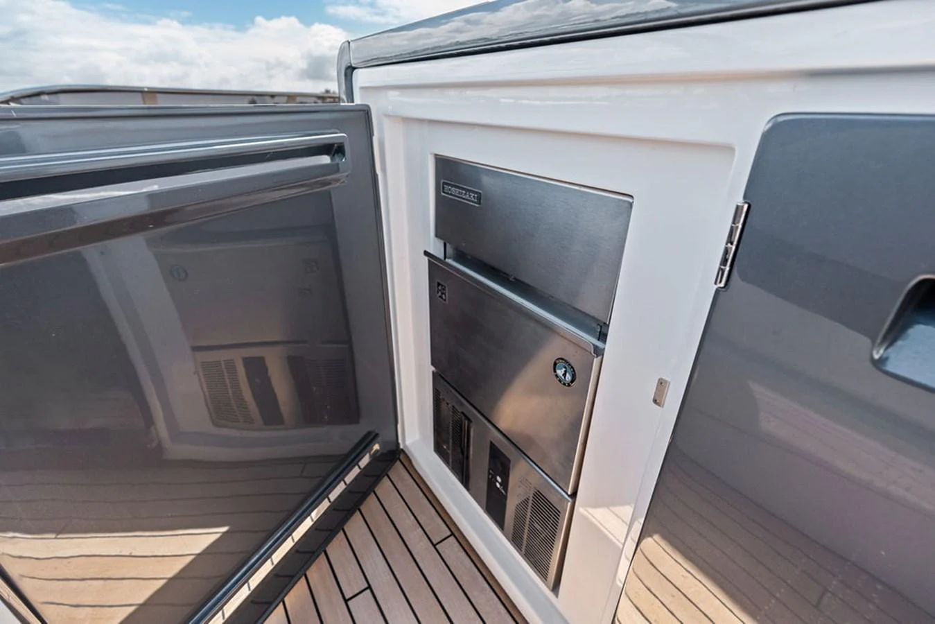 This image showcases a sleek, built-in stainless steel refrigerator on the yacht's deck. aboard DOLCE FAR NIENTE Yacht for Sale