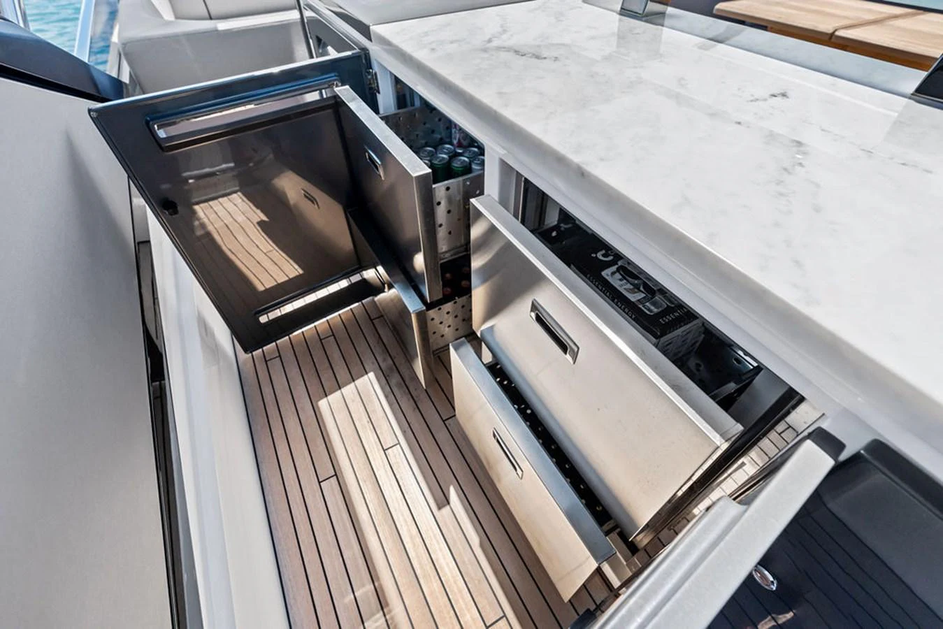 The yacht's galley features sleek stainless steel drawers and a refrigerator, complemented by a marble countertop and teak flooring. aboard DOLCE FAR NIENTE Yacht for Sale