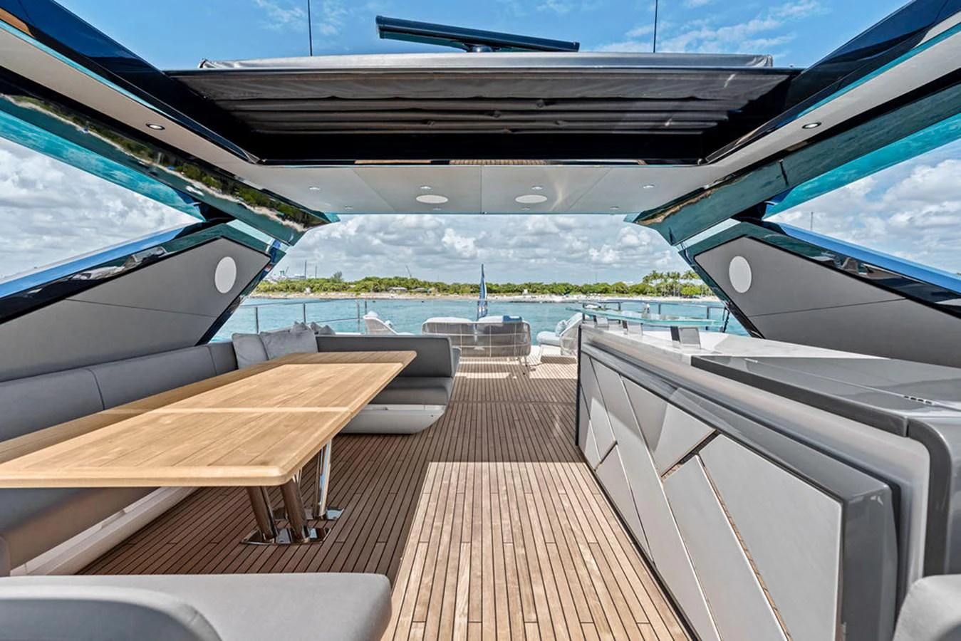 The aft deck features a spacious seating area with a sleek dining table, perfect for alfresco dining. aboard DOLCE FAR NIENTE Yacht for Sale