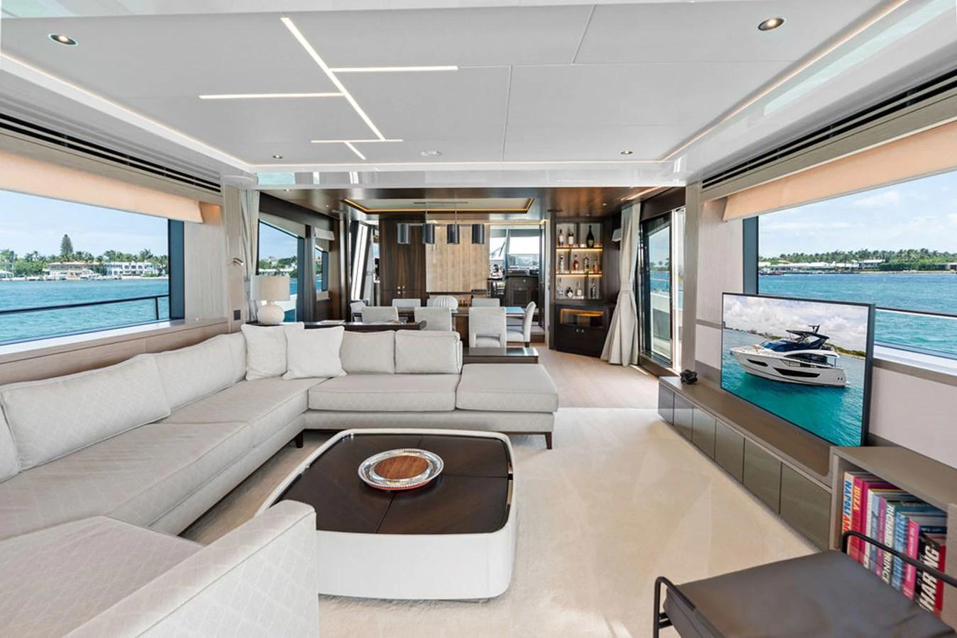 The salon features a spacious and modern design with ample seating and large windows offering stunning views. aboard DOLCE FAR NIENTE Yacht for Sale