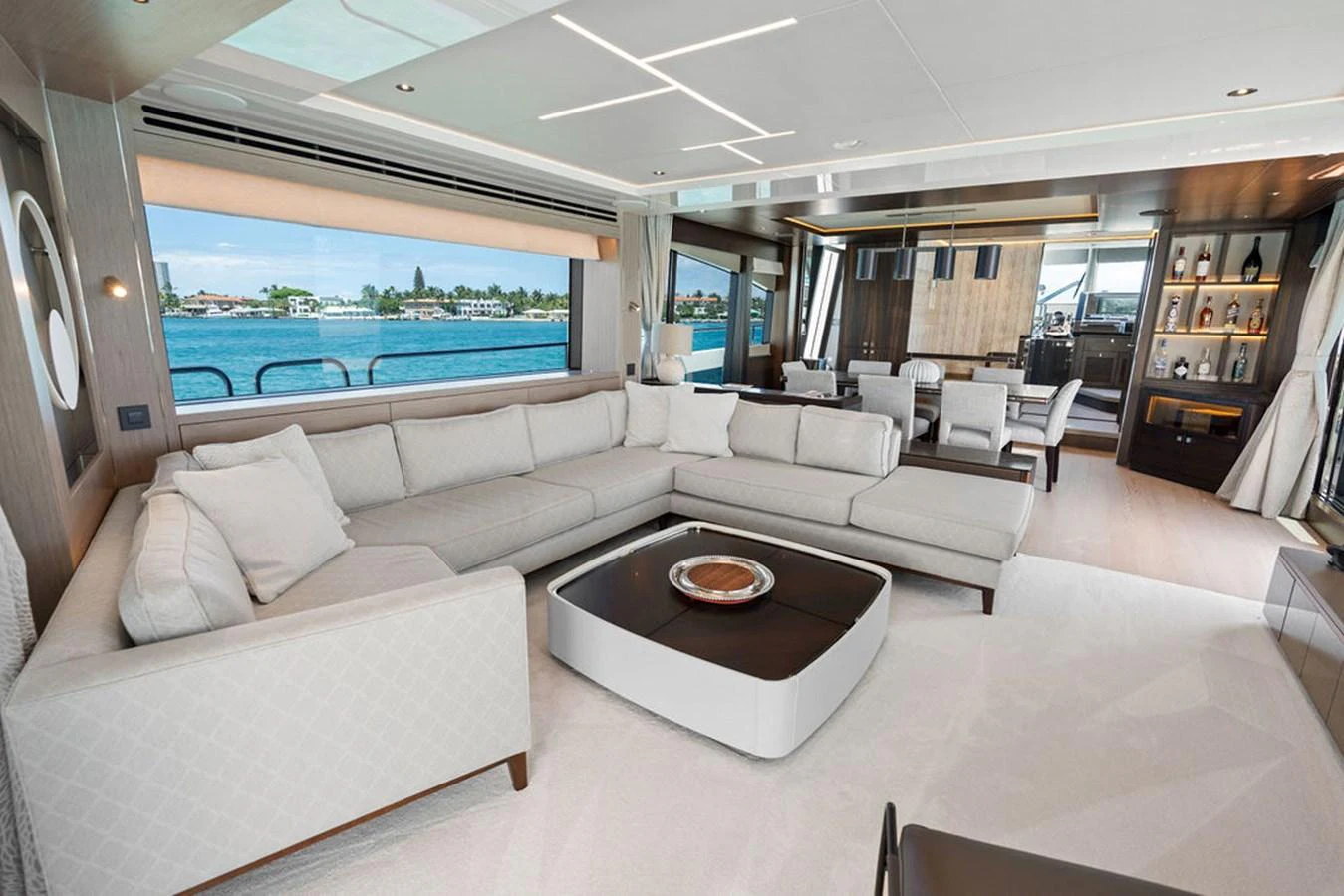 The yacht's salon features a spacious and elegant seating area with large windows offering stunning views. aboard DOLCE FAR NIENTE Yacht for Sale