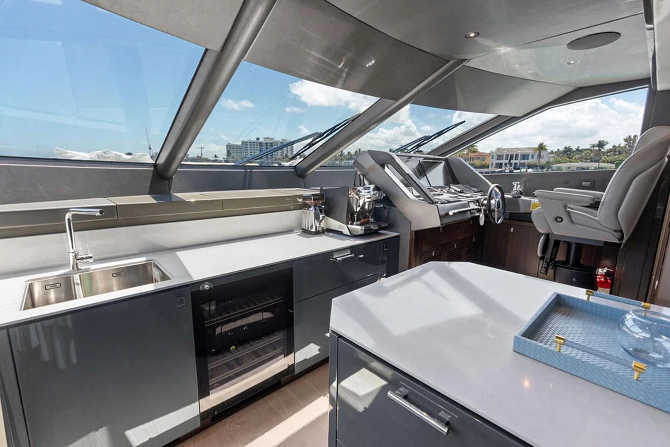 The helm area features a sleek design with modern amenities and expansive windows offering panoramic views. aboard DOLCE FAR NIENTE Yacht for Sale
