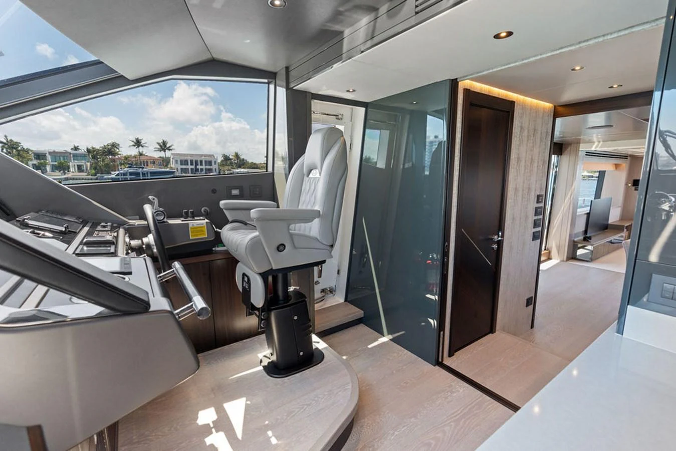 The helm station features a modern captain's chair and state-of-the-art navigation equipment, with a view of the surrounding waters. aboard DOLCE FAR NIENTE Yacht for Sale
