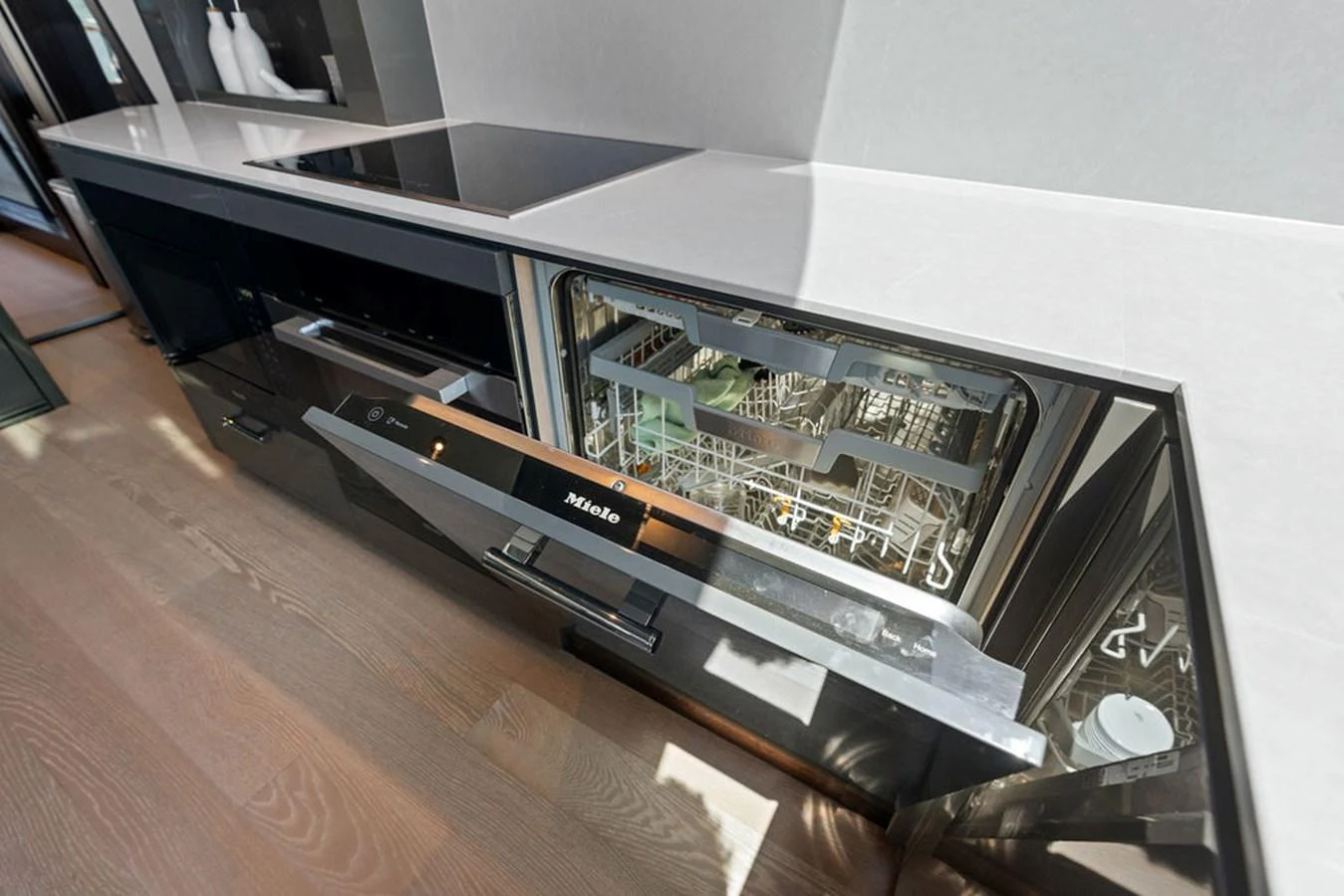 The modern galley features a sleek, built-in dishwasher and induction cooktop. aboard DOLCE FAR NIENTE Yacht for Sale
