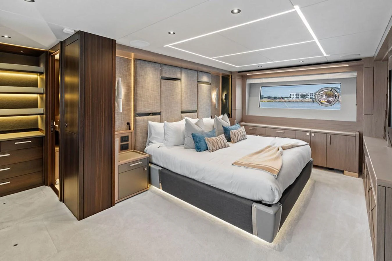 The master stateroom features a spacious bed, elegant wood finishes, and ample natural light. aboard DOLCE FAR NIENTE Yacht for Sale