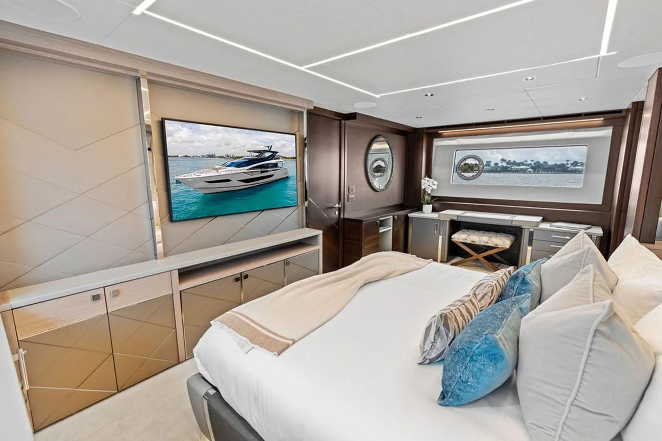 The master stateroom features a luxurious bed, modern decor, and a large window with a stunning view. aboard DOLCE FAR NIENTE Yacht for Sale