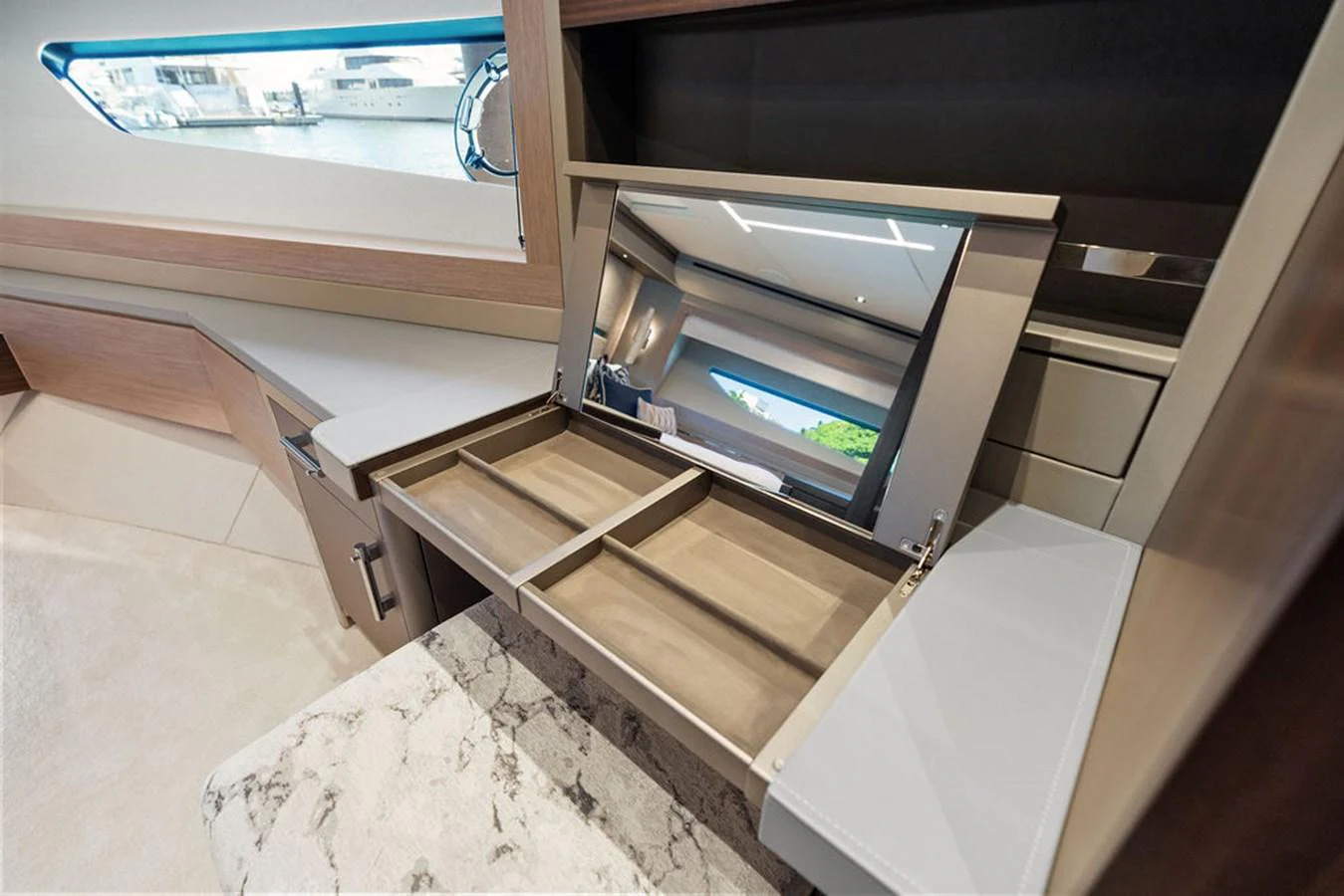 The yacht's interior features a sleek vanity area with a mirror and ample storage space. aboard DOLCE FAR NIENTE Yacht for Sale