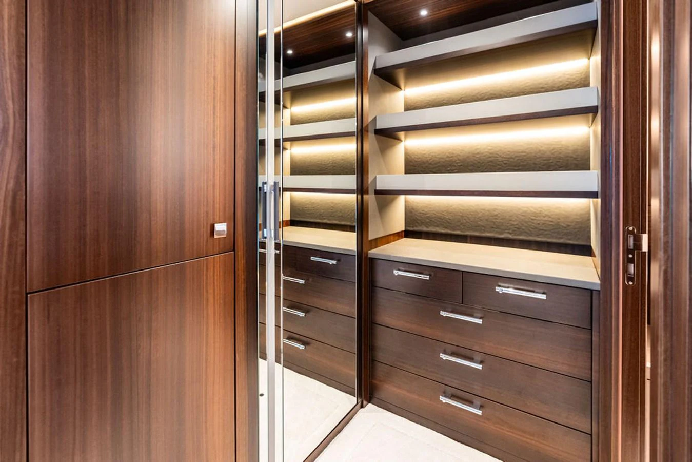 The image showcases a luxurious yacht closet with ample storage space and elegant wooden finishes. aboard DOLCE FAR NIENTE Yacht for Sale
