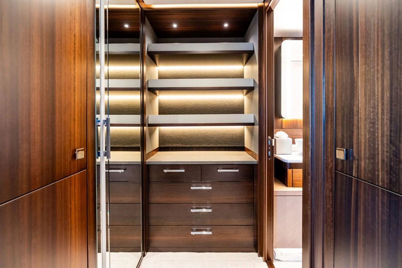 A luxurious yacht interior featuring elegant wooden cabinetry and modern lighting. aboard DOLCE FAR NIENTE Yacht for Sale