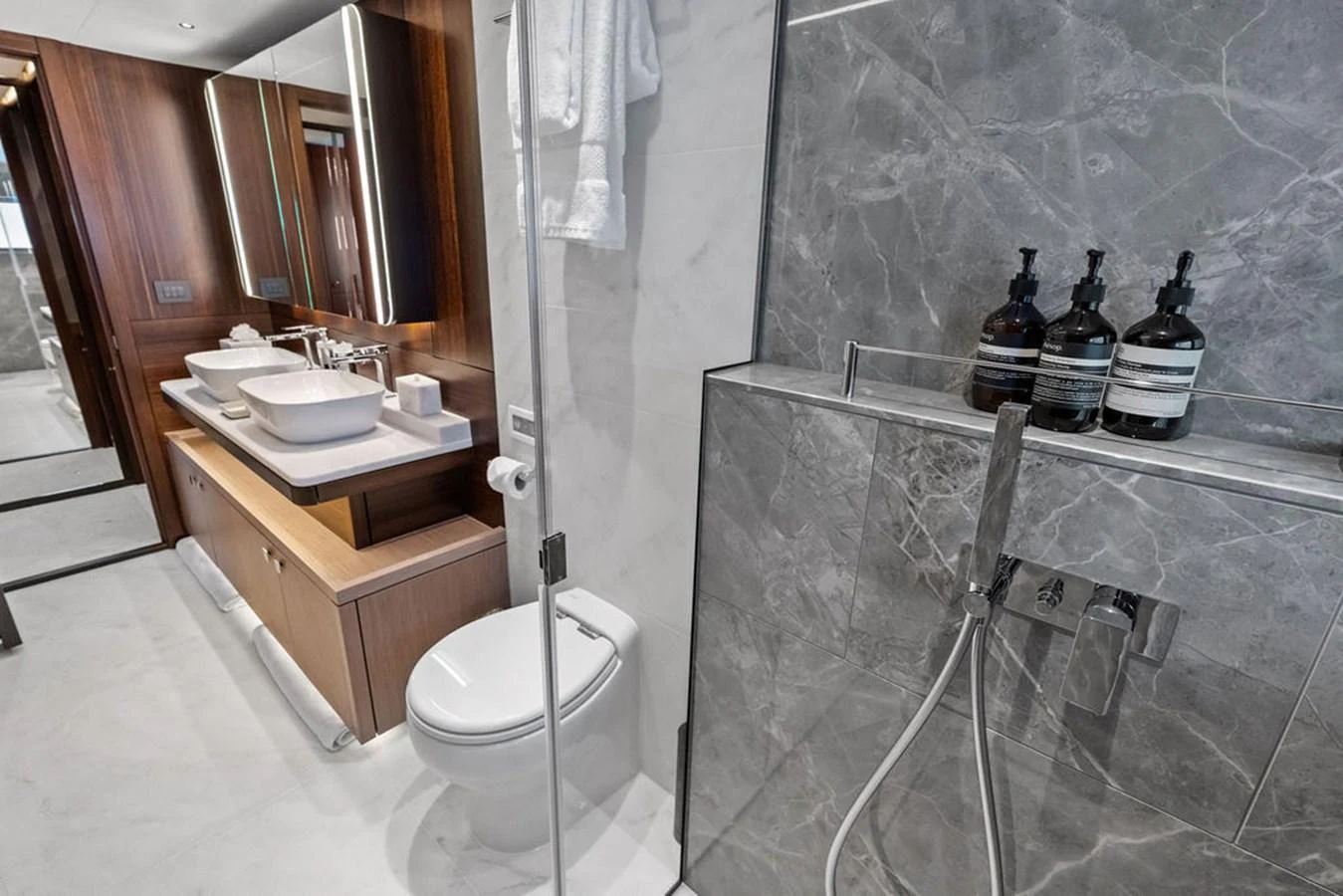 This luxurious yacht bathroom features modern fixtures and elegant marble finishes. aboard DOLCE FAR NIENTE Yacht for Sale