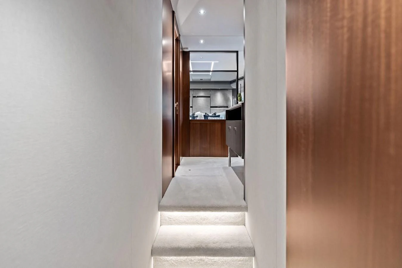A sleek and modern hallway with wooden accents and soft lighting leads to a luxurious interior space. aboard DOLCE FAR NIENTE Yacht for Sale