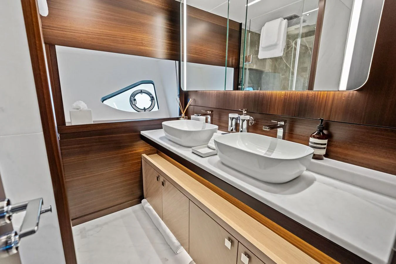 The yacht's bathroom features modern fixtures and a sleek design with dual sinks and ample storage. aboard DOLCE FAR NIENTE Yacht for Sale