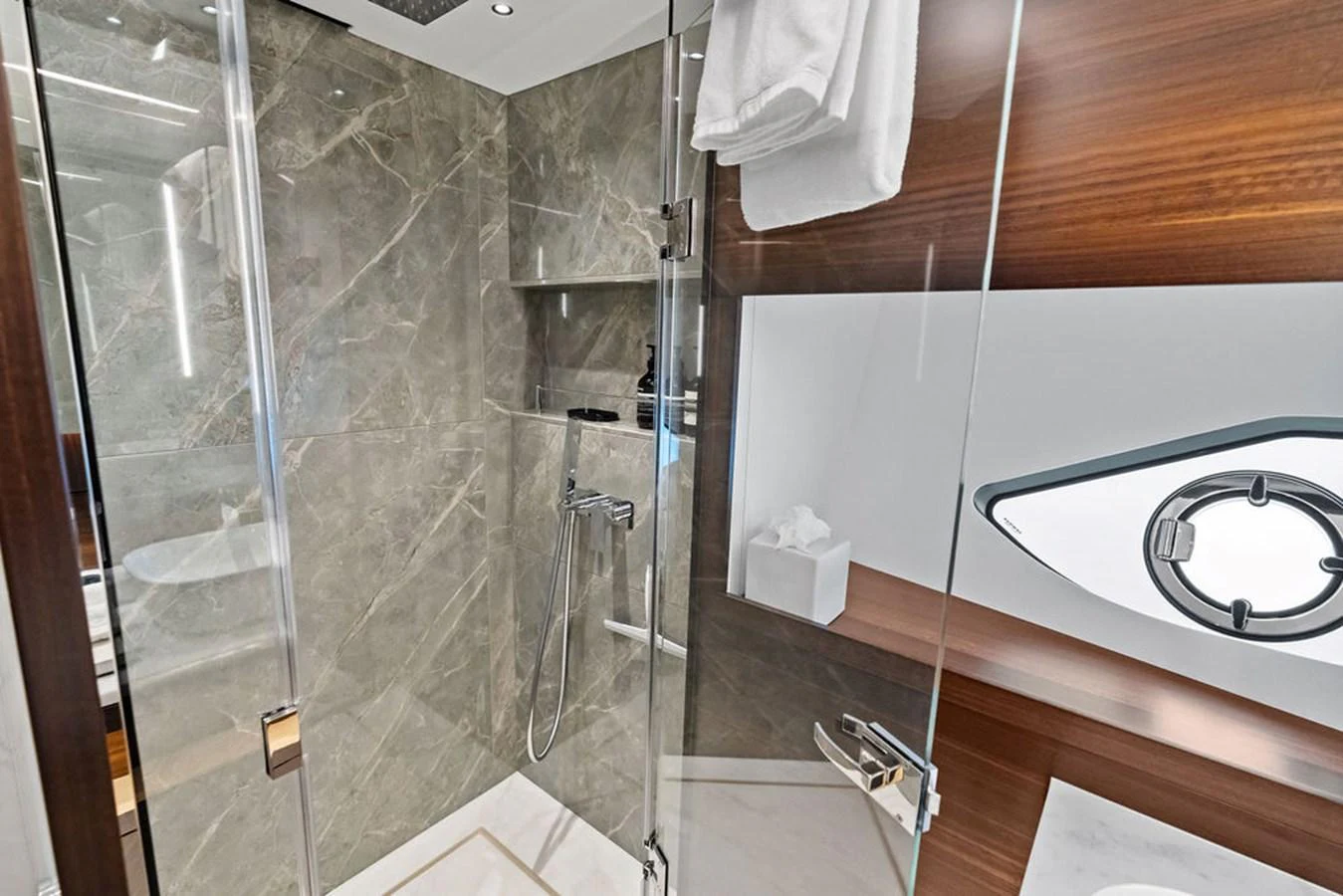 The yacht's bathroom features elegant marble walls and modern fixtures. aboard DOLCE FAR NIENTE Yacht for Sale