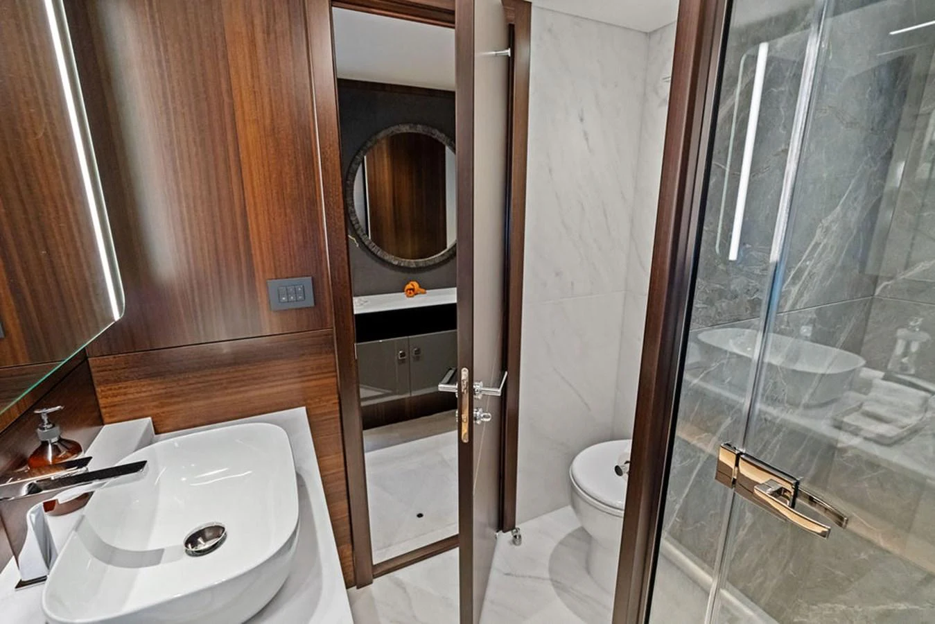The yacht's bathroom features modern fixtures and elegant wood paneling. aboard DOLCE FAR NIENTE Yacht for Sale