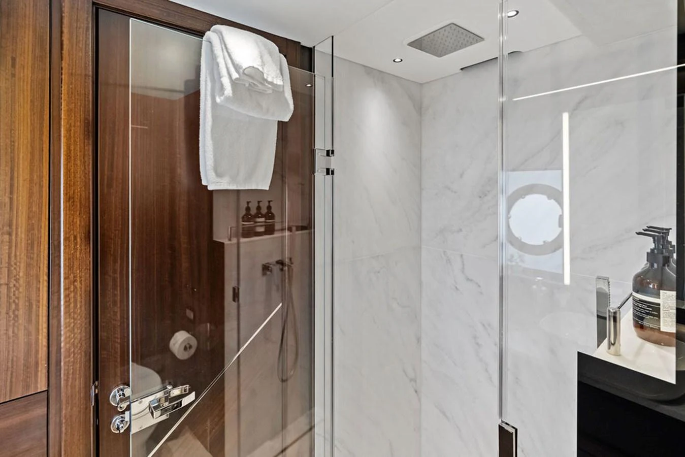 The yacht's bathroom features a sleek, modern design with a glass shower enclosure and luxurious finishes. aboard DOLCE FAR NIENTE Yacht for Sale