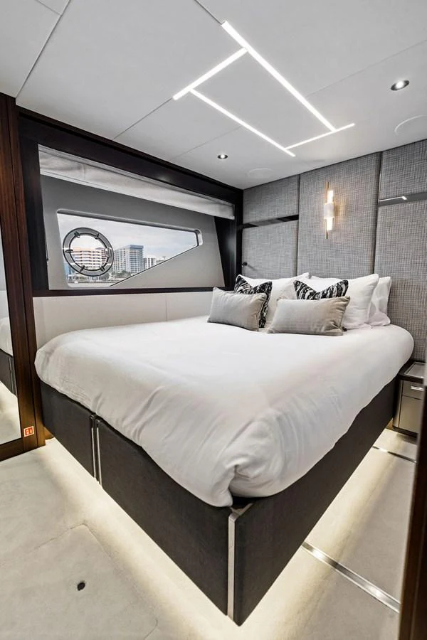The stateroom features a luxurious bed with modern lighting and a sleek design. aboard DOLCE FAR NIENTE Yacht for Sale