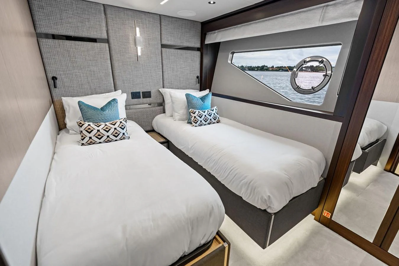 The twin stateroom offers a cozy and elegant retreat with modern decor and a scenic view through the window. aboard DOLCE FAR NIENTE Yacht for Sale