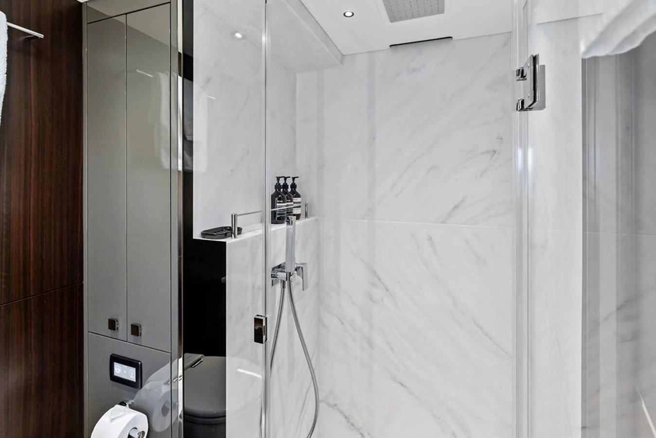 The yacht's bathroom features a sleek, modern design with marble walls and high-end fixtures. aboard DOLCE FAR NIENTE Yacht for Sale