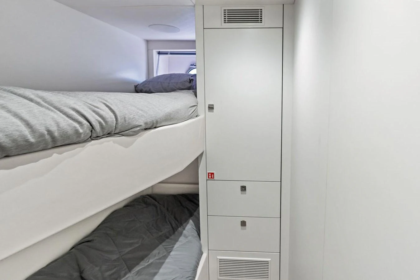The image showcases a compact and modern bunk room with clean lines and minimalist design. aboard DOLCE FAR NIENTE Yacht for Sale