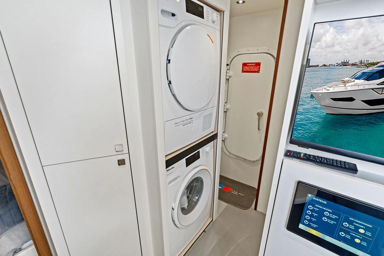 The yacht features a well-equipped laundry area with modern appliances and a view of the water through a nearby window. aboard DOLCE FAR NIENTE Yacht for Sale