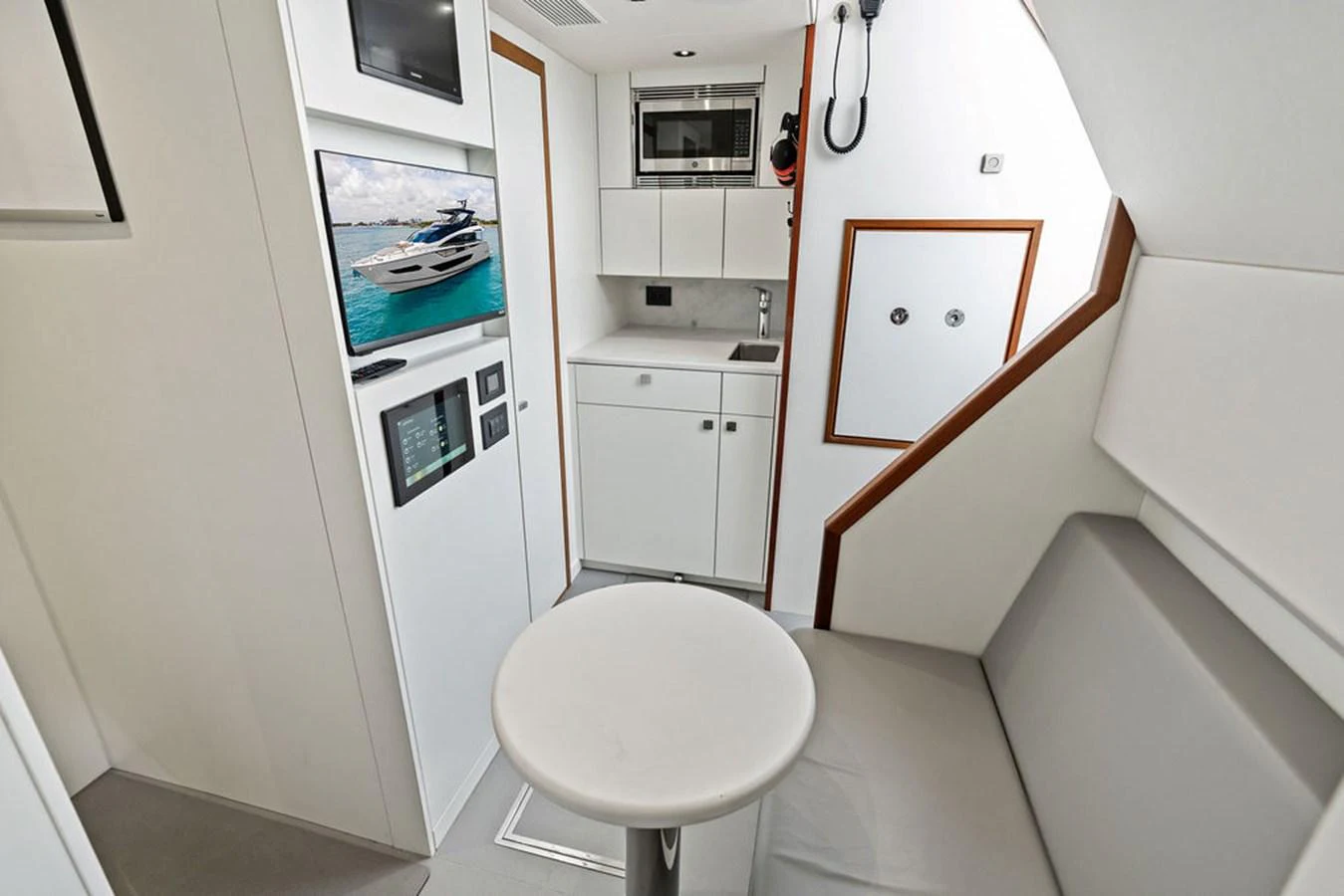 A compact and modern galley area with sleek white cabinetry and integrated appliances. aboard DOLCE FAR NIENTE Yacht for Sale