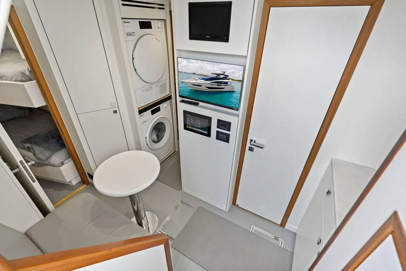 The yacht's interior features a compact and functional laundry area with modern appliances and a small seating space. aboard DOLCE FAR NIENTE Yacht for Sale