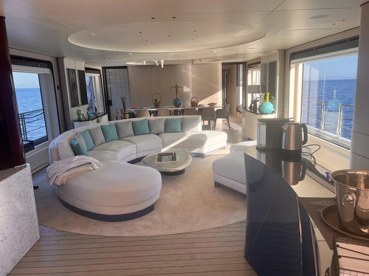 The spacious salon features elegant furnishings and panoramic ocean views. aboard DAGUSHA V Yacht for Sale