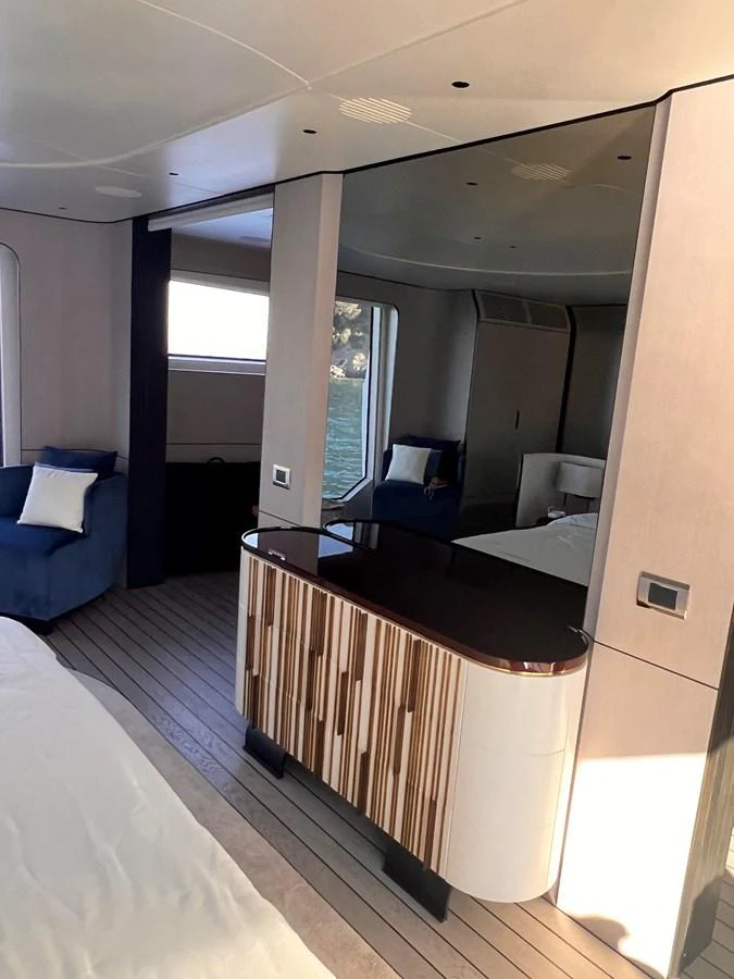 A luxurious stateroom featuring modern furnishings and large windows with a serene view. aboard DAGUSHA V Yacht for Sale