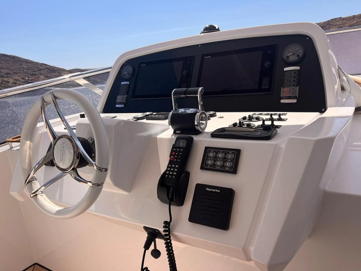 The helm station features modern navigation equipment and a sleek steering wheel. aboard DAGUSHA V Yacht for Sale