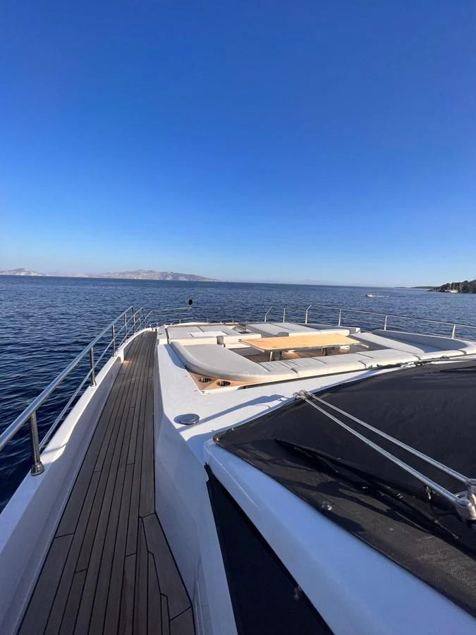 The yacht's foredeck offers a spacious sunbathing area with stunning ocean views. aboard DAGUSHA V Yacht for Sale