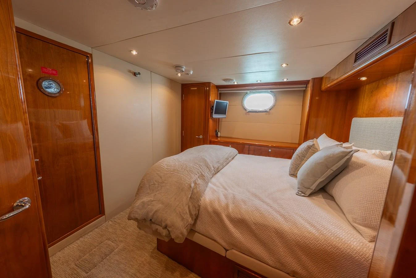 A cozy stateroom with a plush bed and warm wood finishes. aboard HAVILAH Yacht for Sale