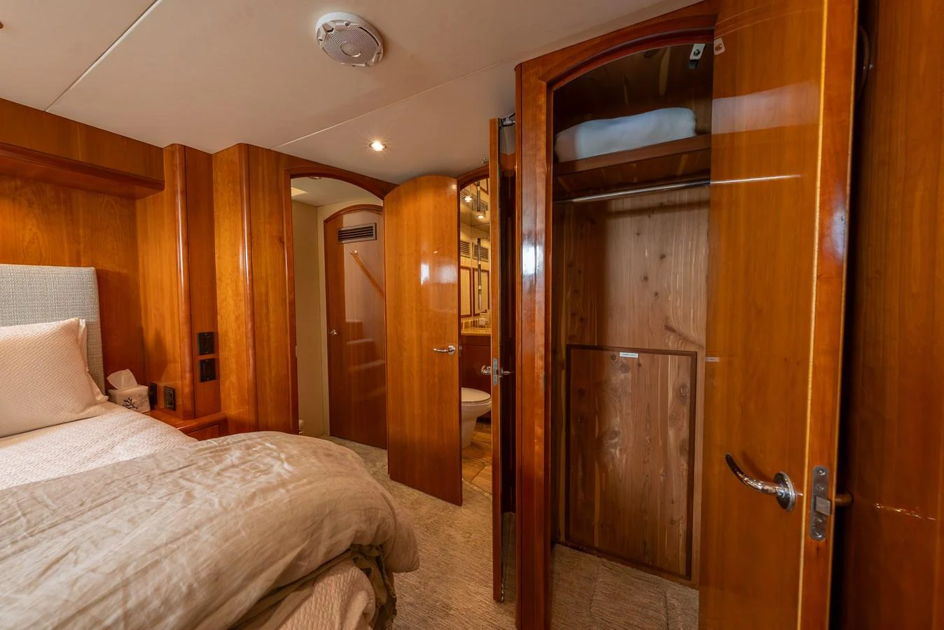 A cozy stateroom with wooden finishes and a comfortable bed. aboard HAVILAH Yacht for Sale