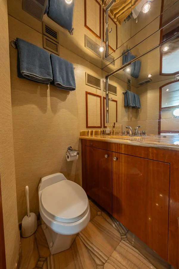 The yacht's bathroom features elegant wood cabinetry and modern fixtures. aboard HAVILAH Yacht for Sale