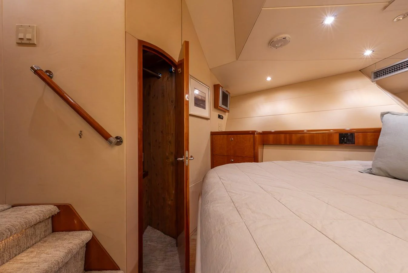 A cozy stateroom featuring a comfortable bed and warm lighting. aboard HAVILAH Yacht for Sale